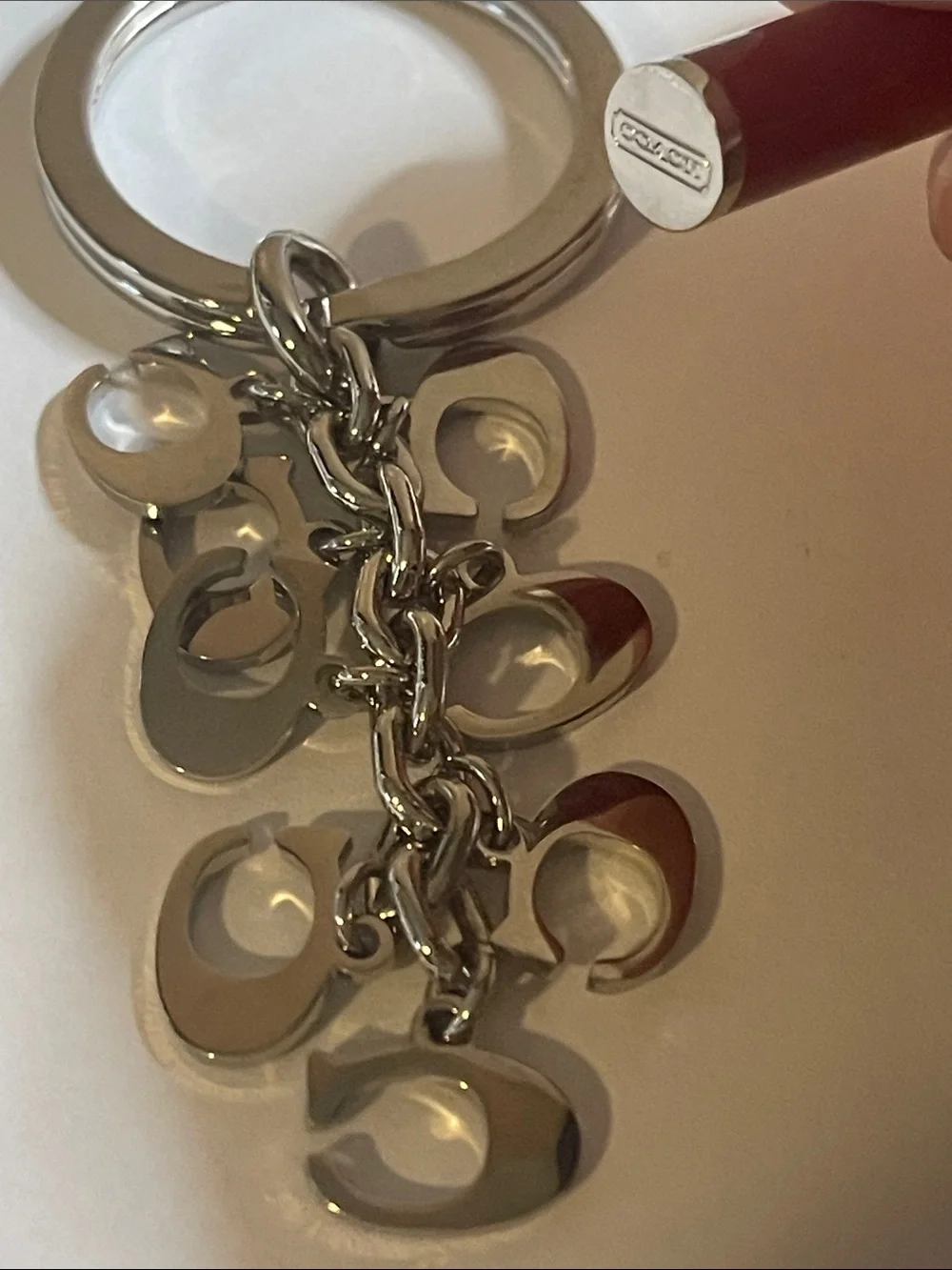 Coach Silver-Tone Keyring with Red Enamel 'C' Charms and Coach Pen